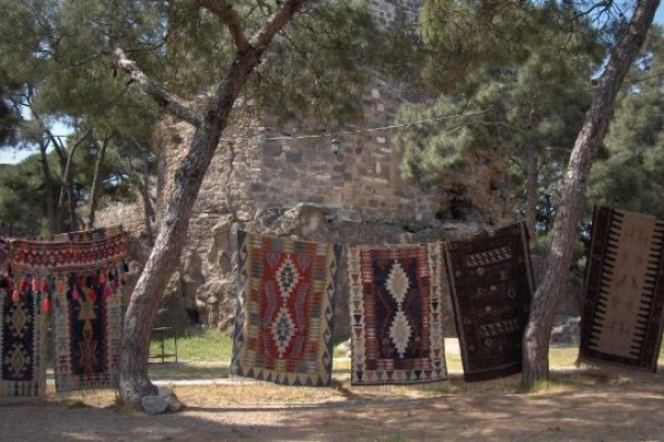 Der Kadifekale Berg im antiken Smyrna mit grandiosem Ausblick von der Akropolis auf Izmir. Und vielen Händlern, die kunstvoll gewebte Teppiche aus Smyrna anbieten. 