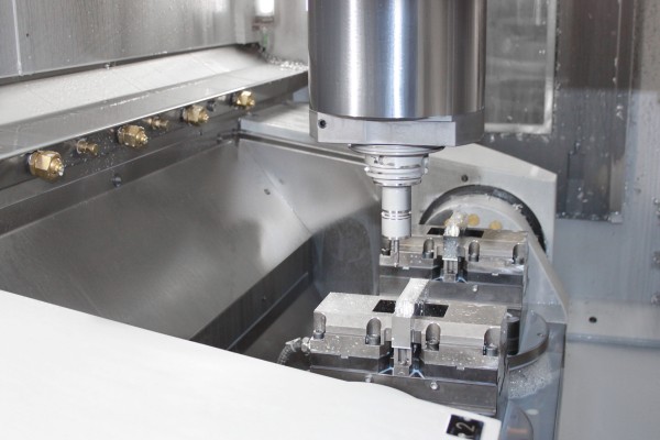  Working area of the vertical CNC machining center with retracted swivel table for successive five-axis complete machining of two workpieces at a time. 